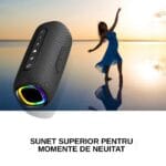 Boxă portabilă neagră cu inel RGB, imagine promo cu fundal apus și siluetă dans, text „Sunet superior pentru momente de neuitat”
